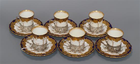 A set of six Aynsley silver mounted porcelain coffee cans and saucers